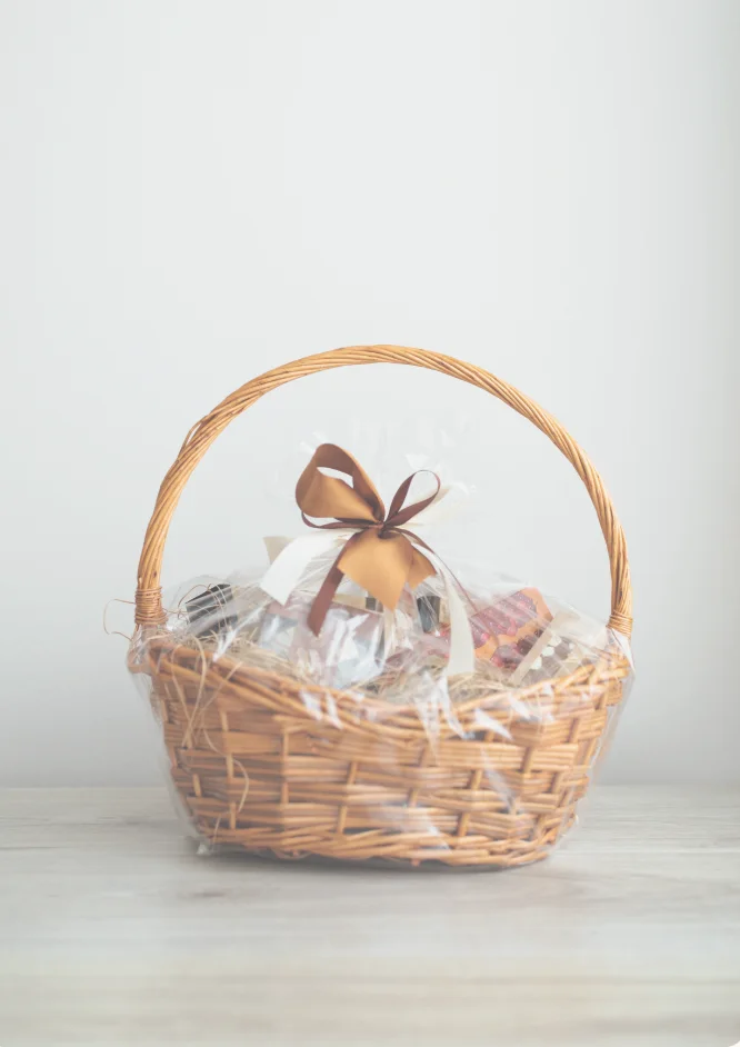A wrapped wicker welcome basket ready for guest arrival